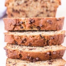 Loaf of chocolate chip banana bread with slices falling over.