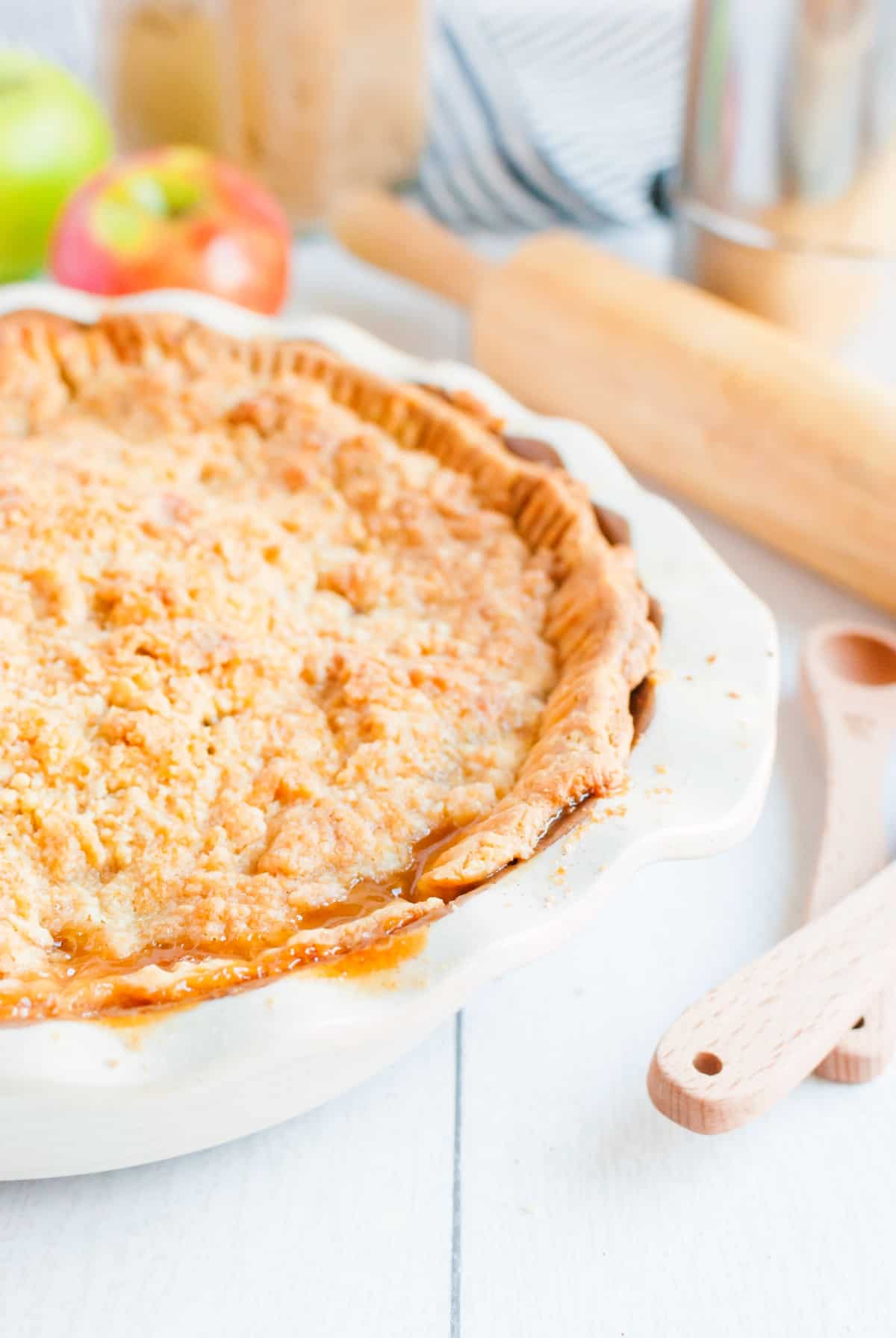 Dutch Apple Pie with streusel topping in a white pie plate.