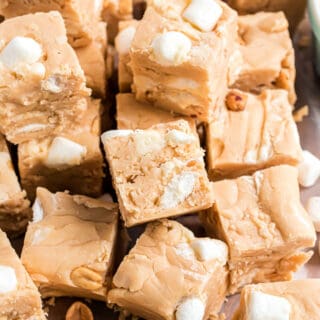 Fluffernutter Fudge is easy to make with no candy thermometer! This rich peanut butter fudge tastes even better when you combine it with marshmallow cream and crunchy nuts.