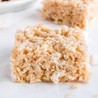 Thick and chewy rice krispie treat cut into a square.