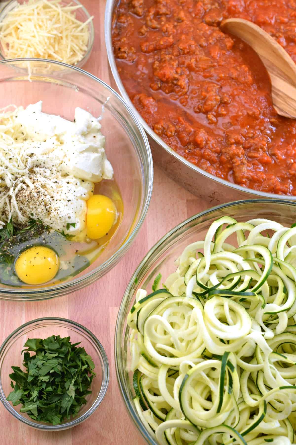 All the ingredients in bowls ready to make zucchini ziti