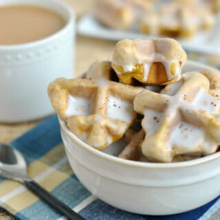 Pumpkin waffle bites in a bowl with cup of coffee.