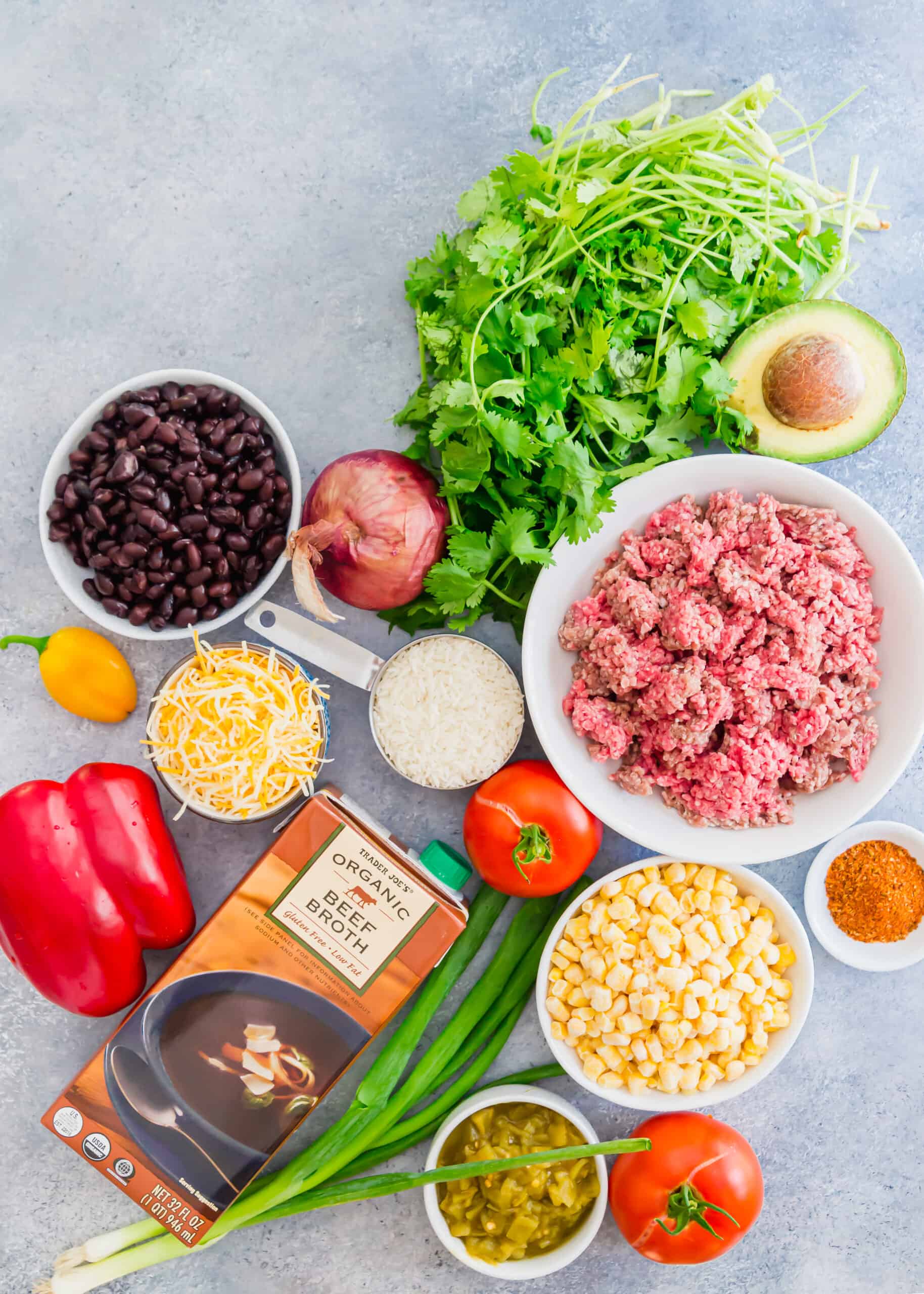 Ingredients needed for beef taco skillet, including ground beef, stock, beans, rice, and more.