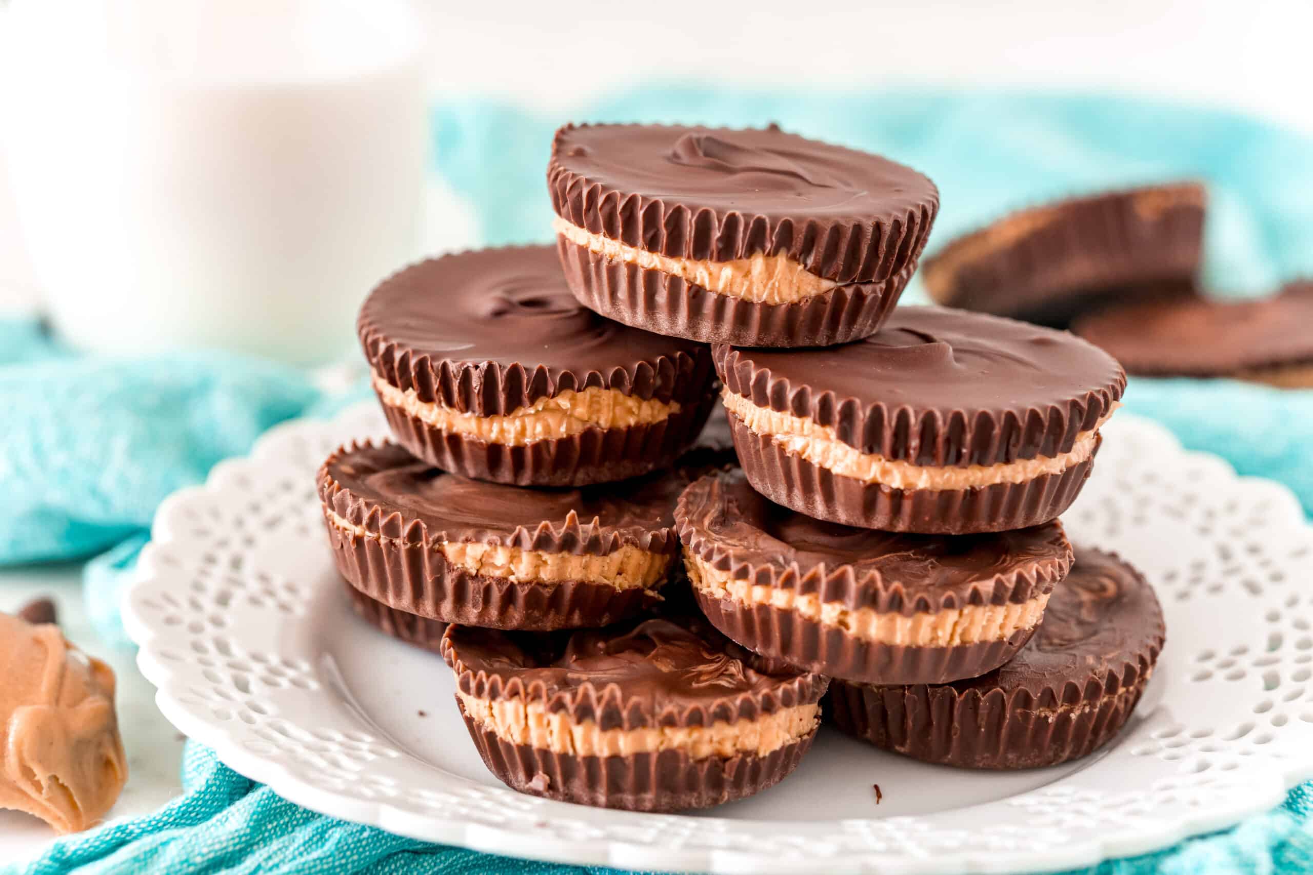 Stack of homemade peanut butter cups on a white plate.