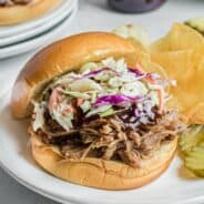 Instant Pot Hawaiian pulled pork on a bun with barbeque sauce and coleslaw.