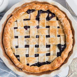 Blueberry pie with lattice pie crust in a deep dish pie plate.