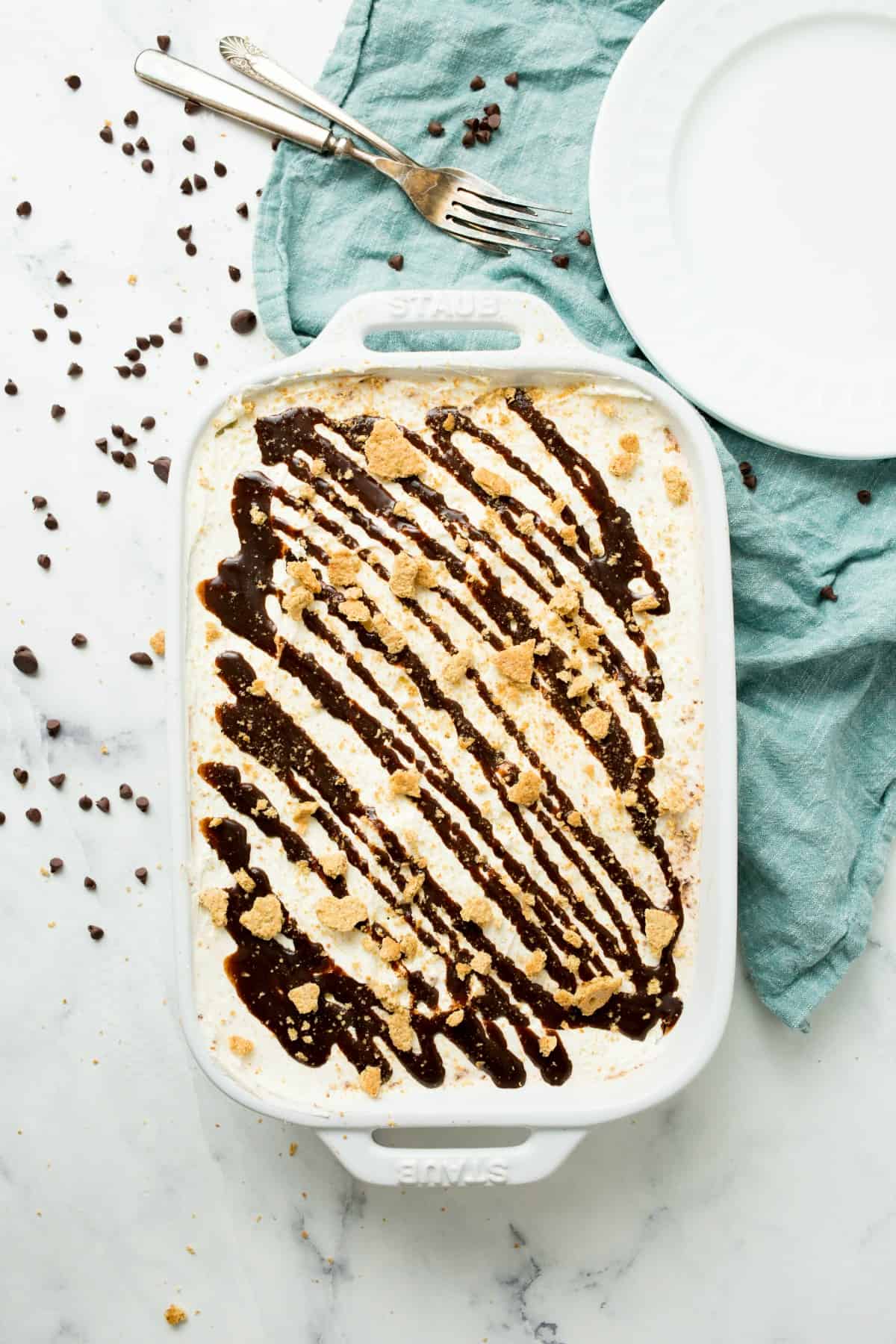 Top view of a smores icebox cake drizzled with chocolate syrup.