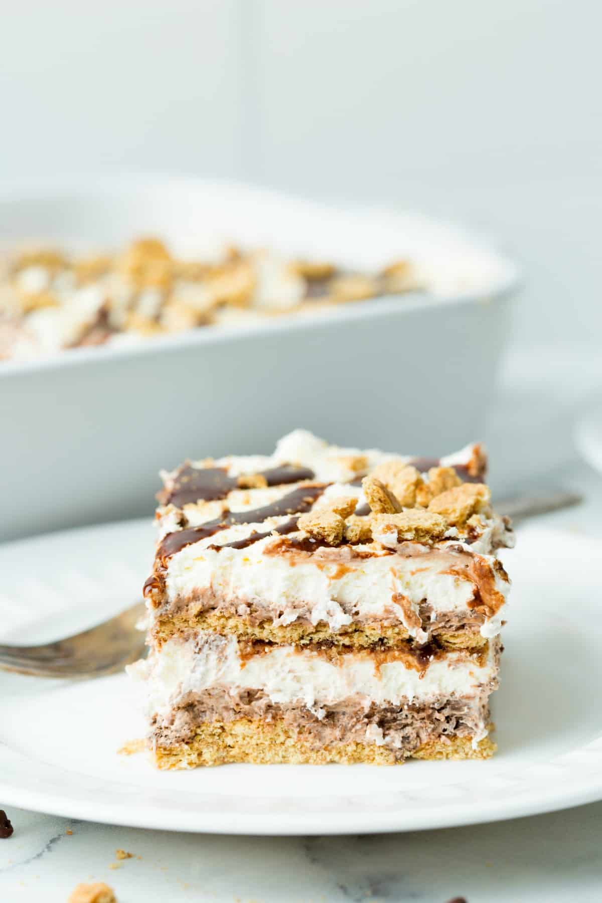 Slice of smores icebox cake on a white dessert plate.