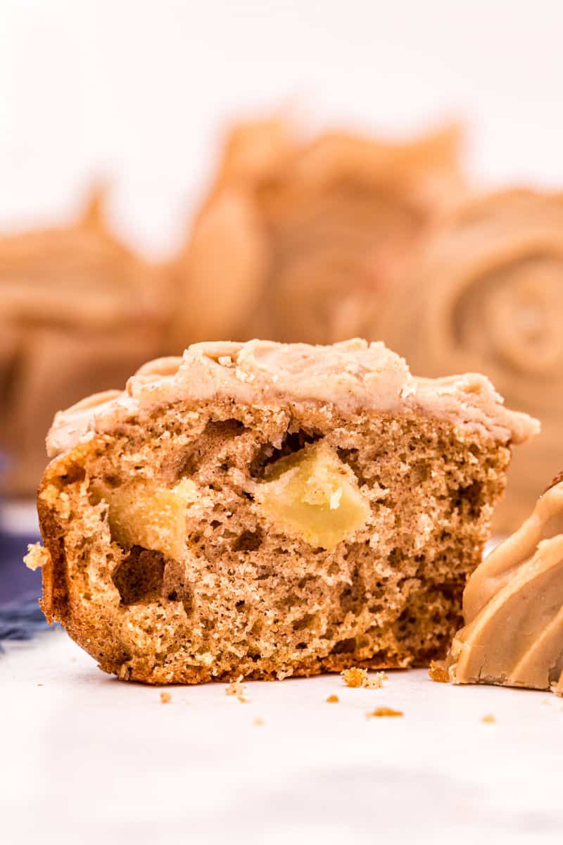 Apple muffin sliced in half with a caramel glaze on top.