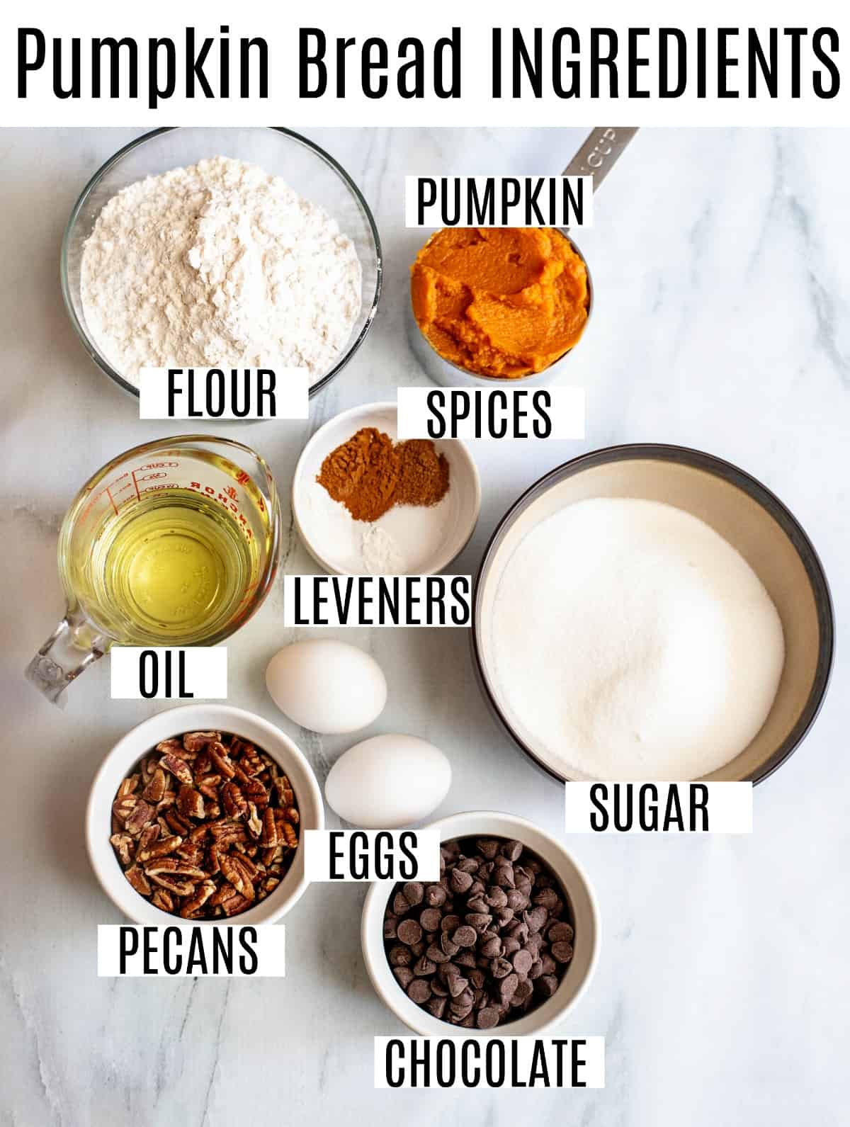 Ingredients needed for pumpkin bread including canned pumpkin, chocolate chips, and pecans.