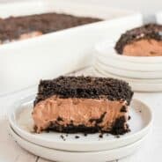 Chocolate dirt oreo cake slice on a white plate.