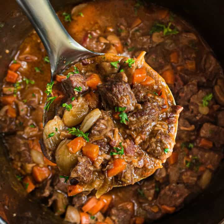 Close up shot of beef stew on a ladle.
