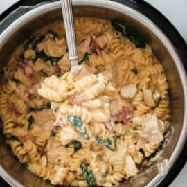 Crack chicken pasta being ladled out of a pressure cooker.