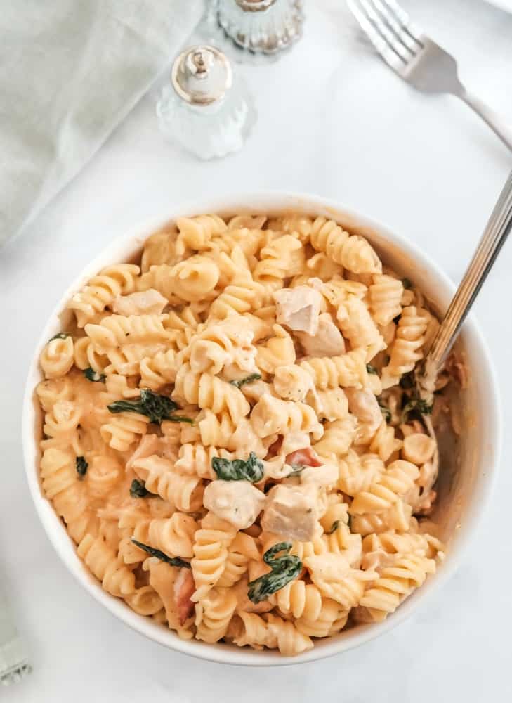 Crack chicken pasta in white serving bowl.