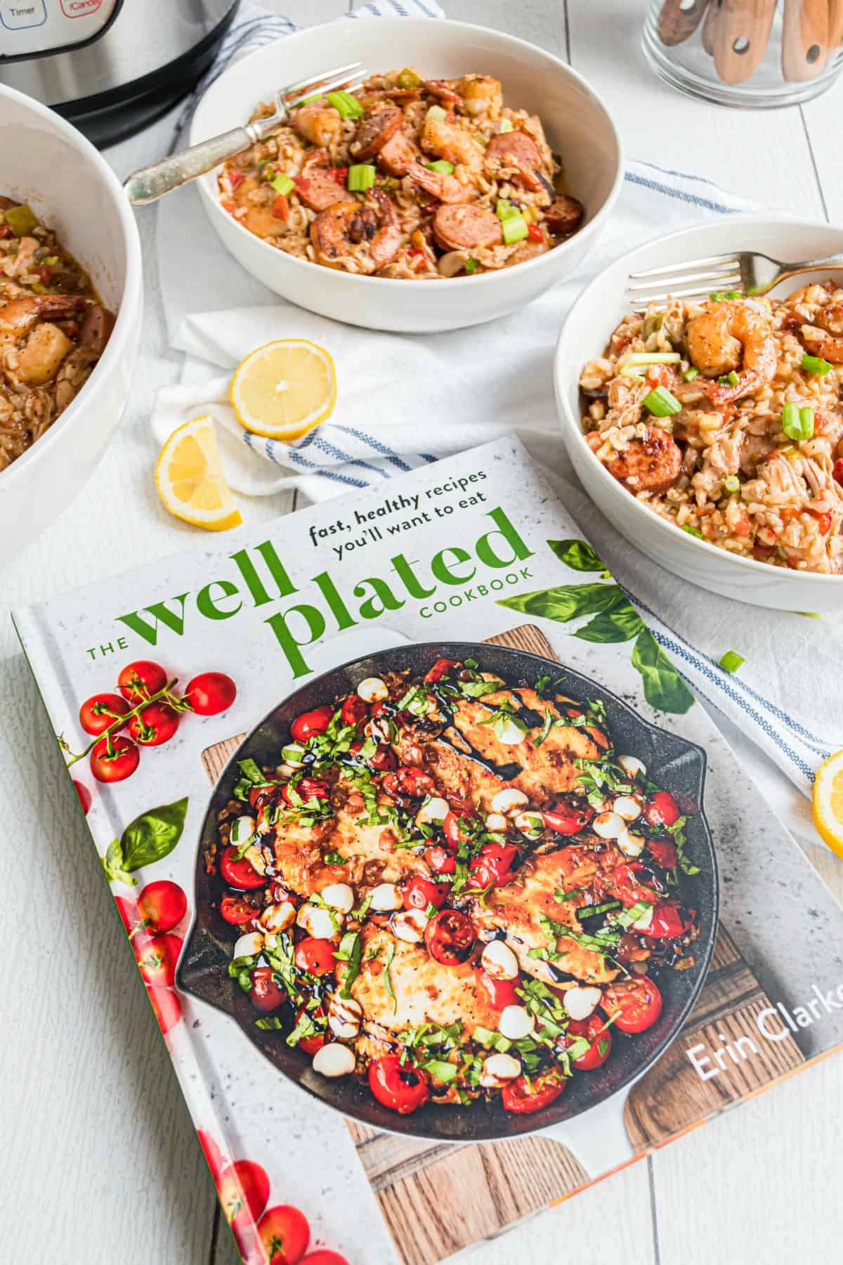 Photo of the Well Plated cookbook with jambalaya in background.