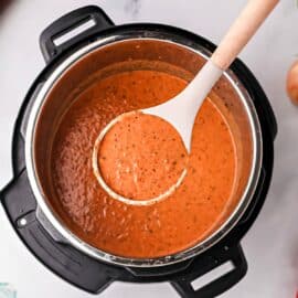 Tomato soup being ladled out of the Instant Pot.