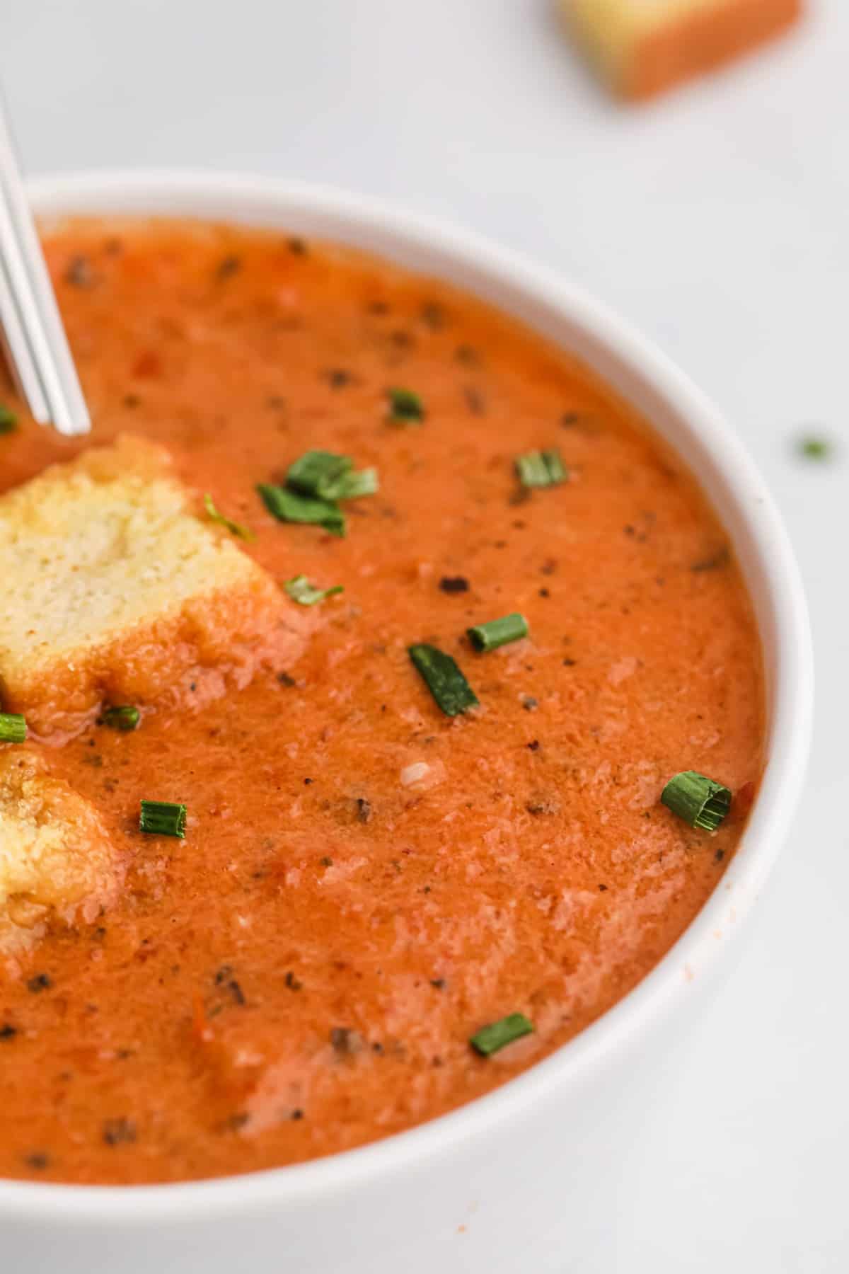 Close up of tomato soup with croutons.
