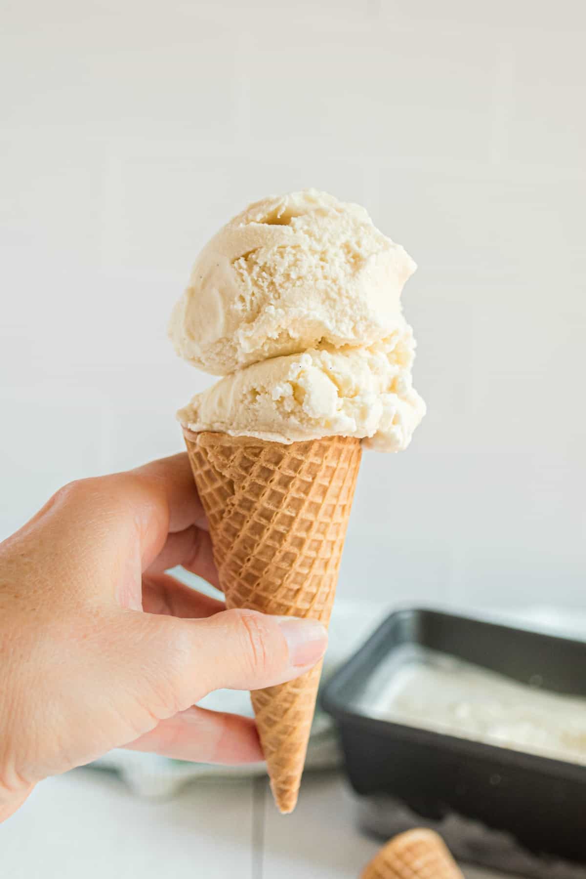 Vanilla ice cream on a sugar cone.