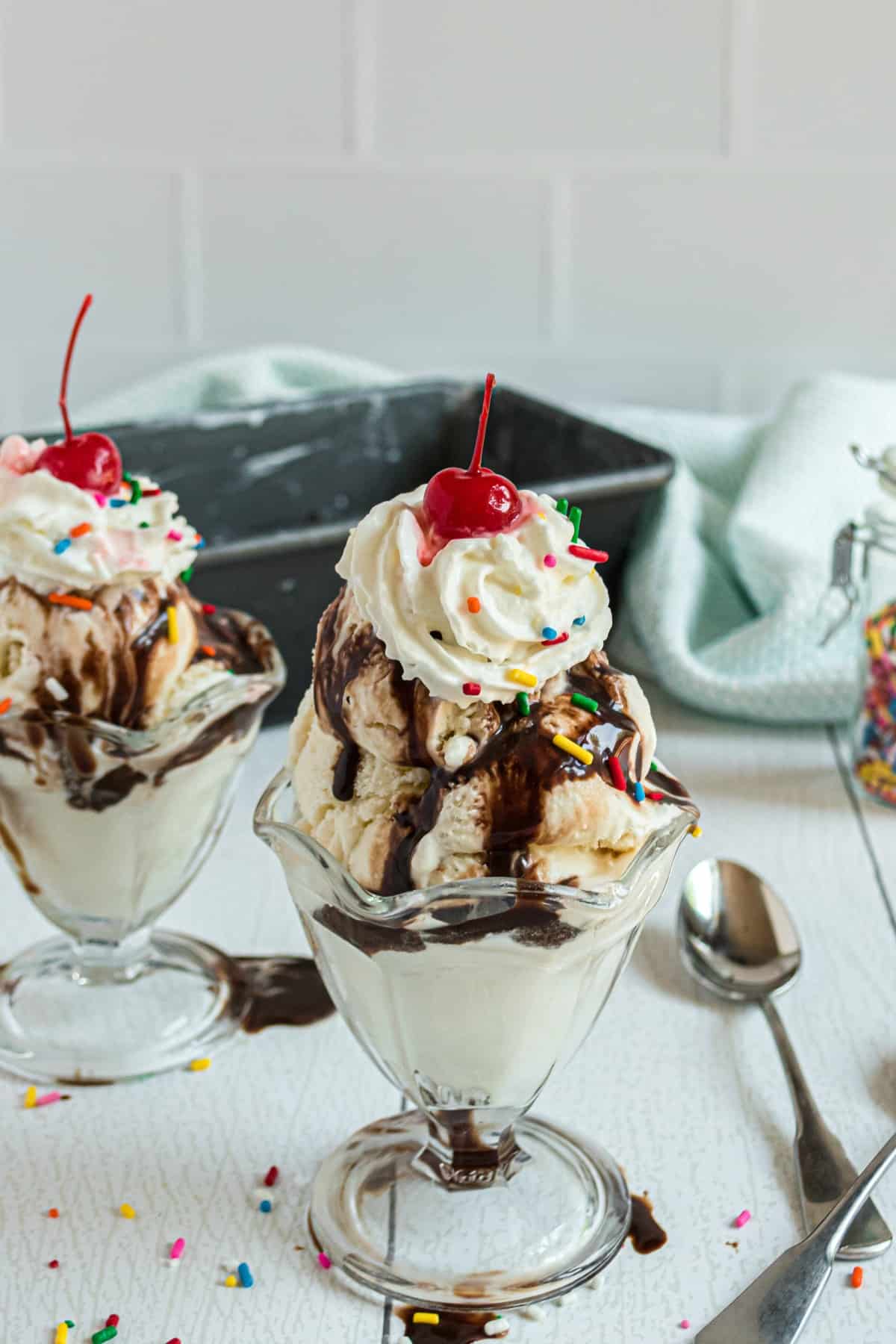 Vanilla ice cream sundae with chocolate, whipped cream, and a cherry.