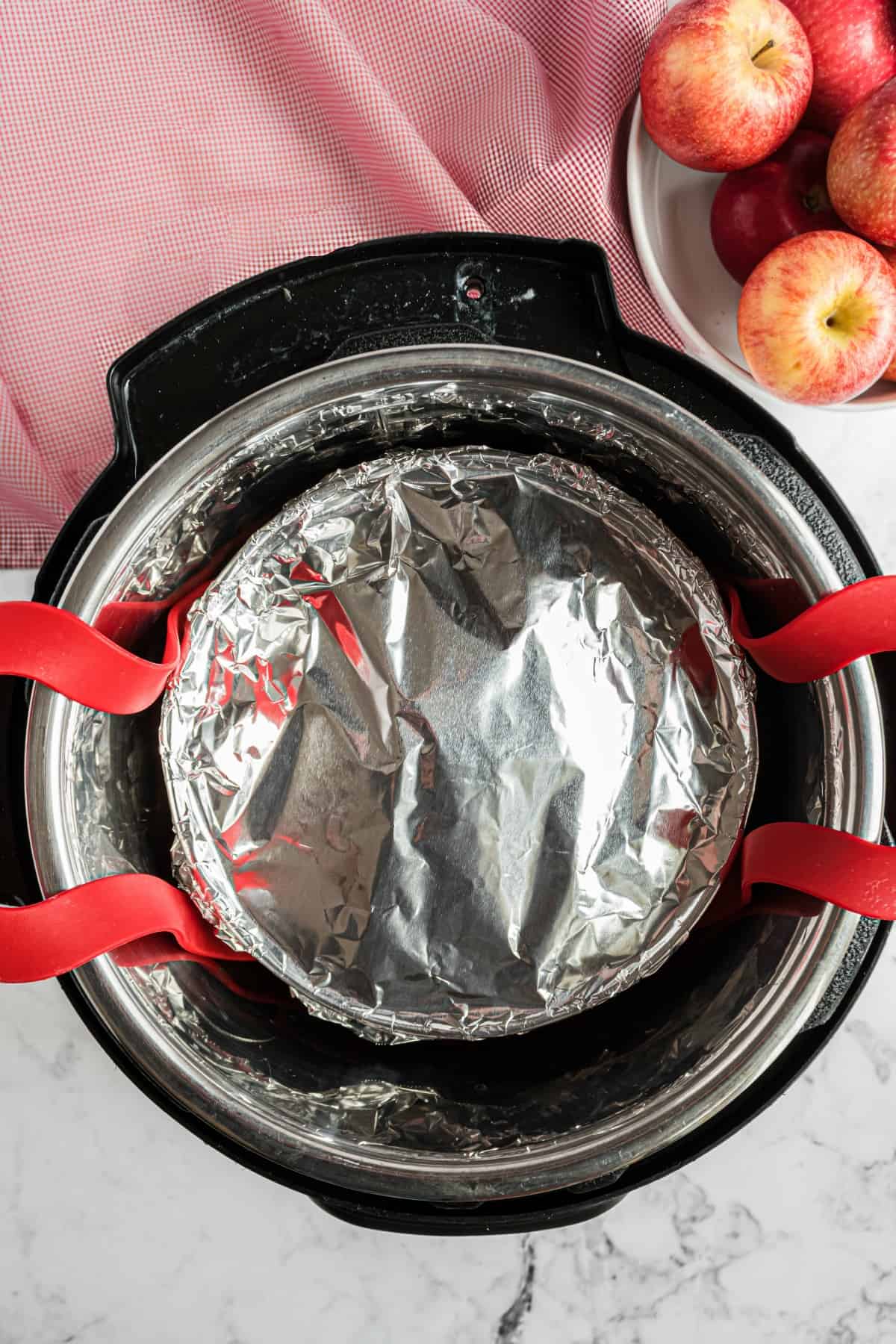 Foil covered dish in instant pot on a sling.