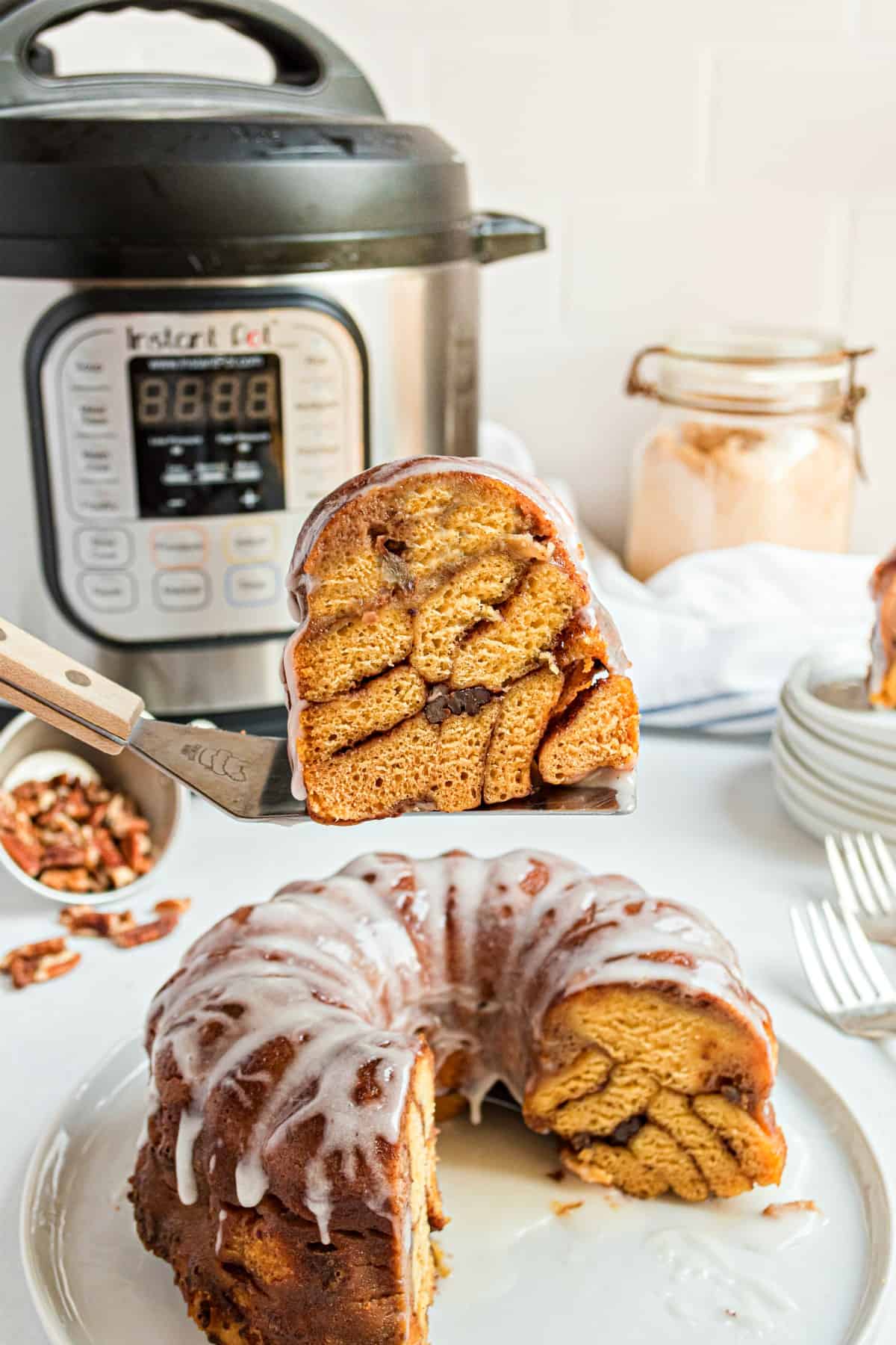 Thick slice of cinnamon roll bread revealing the layers of cinnamon pecans and rolls.