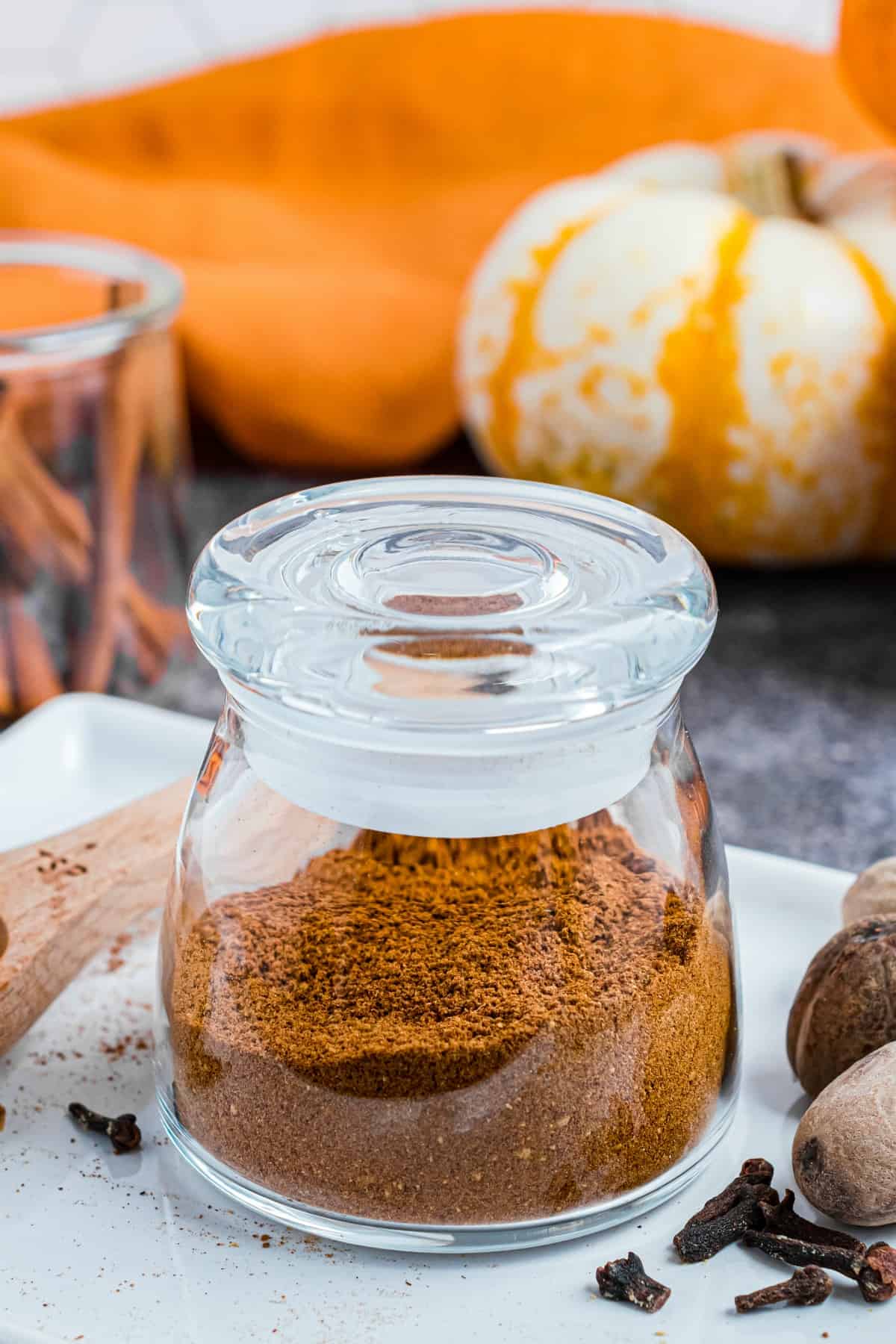 Glass jar with lid filled with homemade pumpkin pie spice substitute.