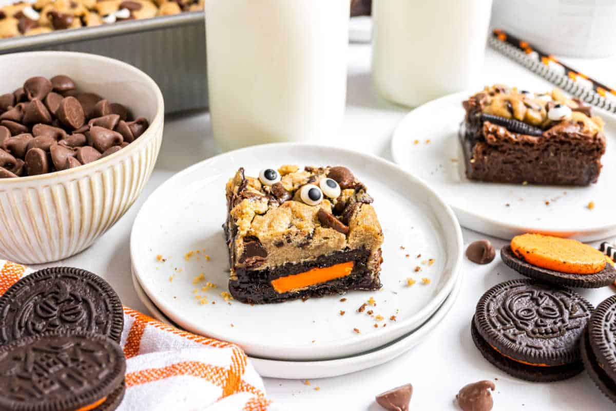 A spooky brookie Halloween treat topped with googly eyes and chocolate chips, featuring an orange creme Oreo at the base.