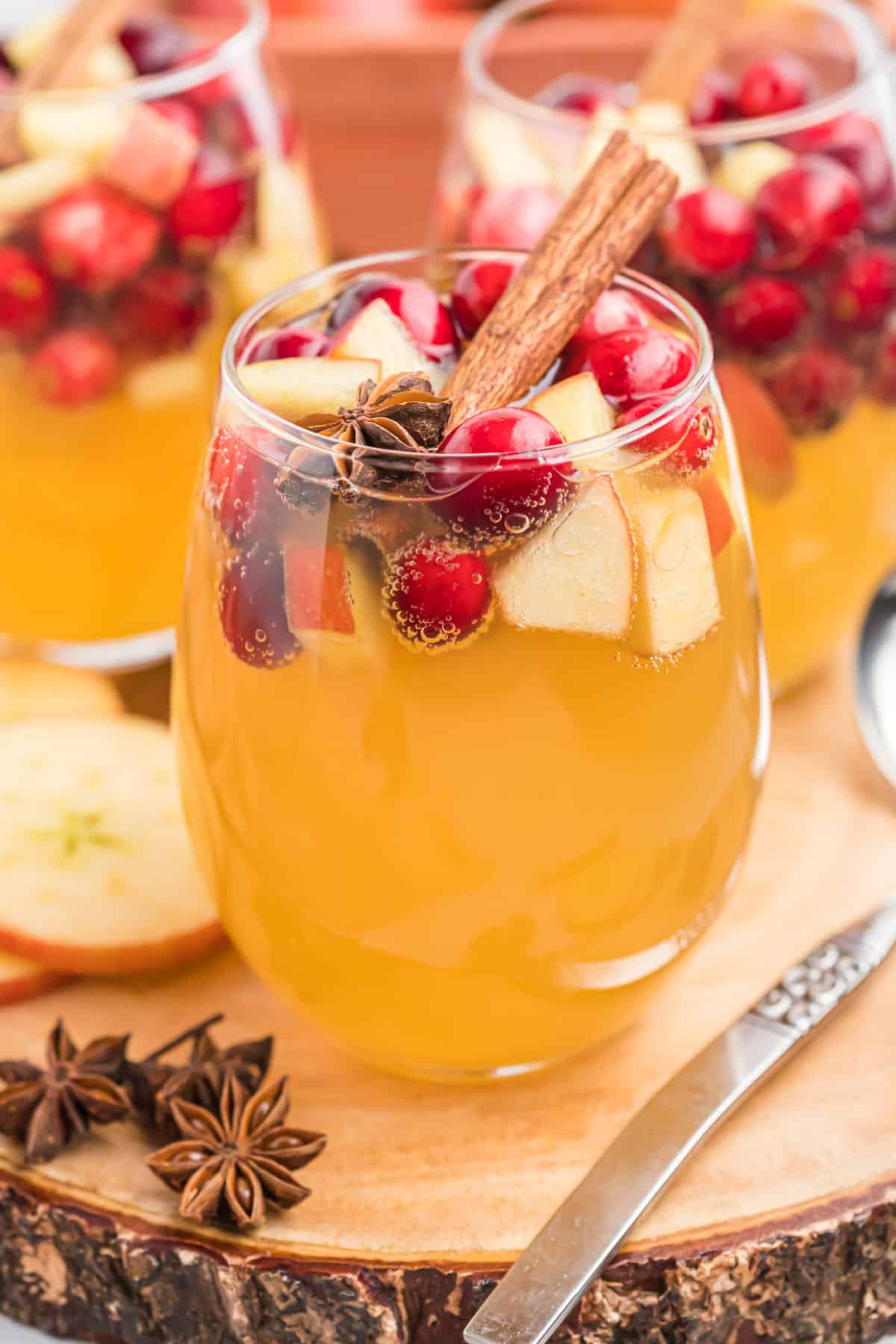 Apple cider sangria in a stemless wine glass.