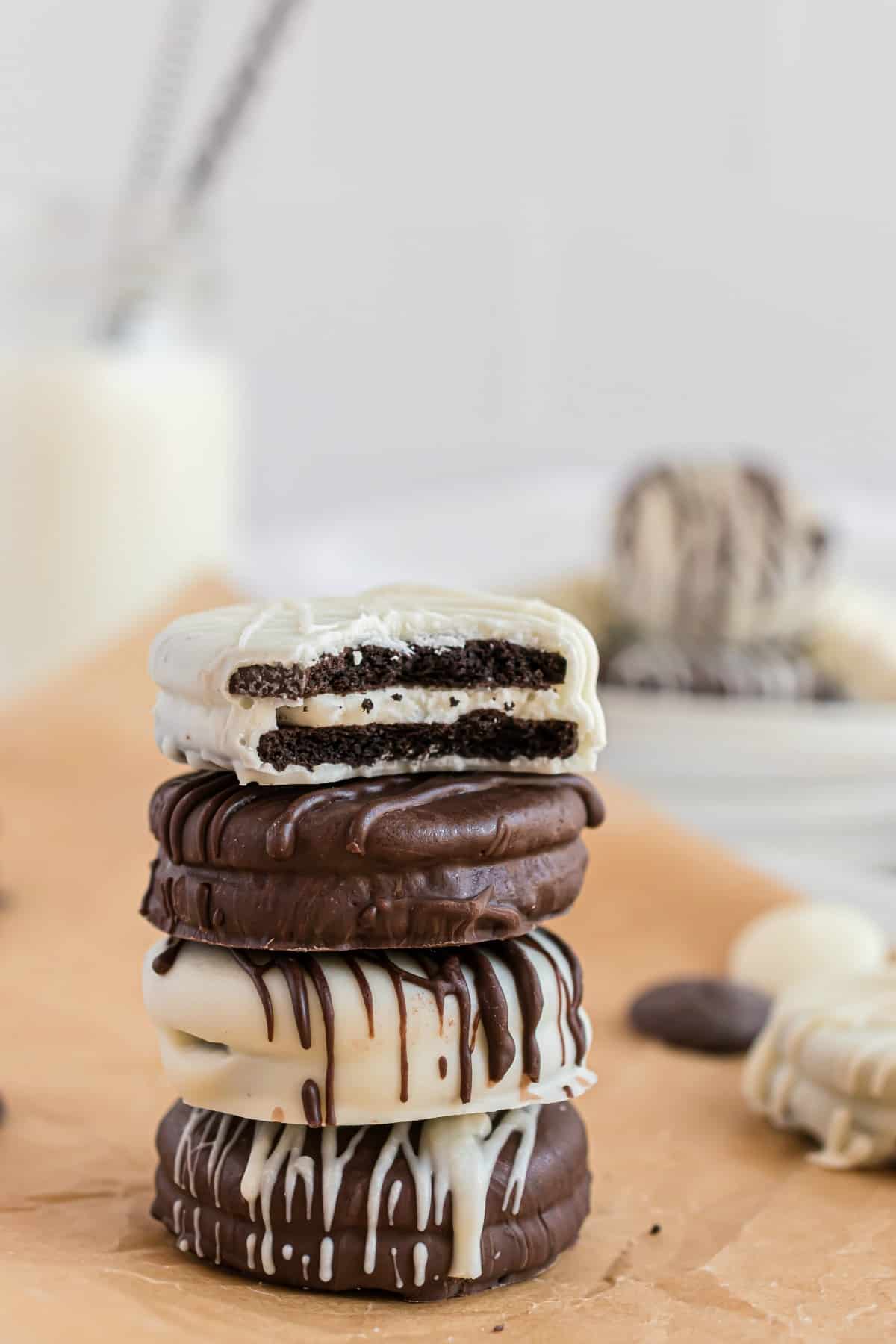 Chocolate covered oreos in a stack, one bite removed.