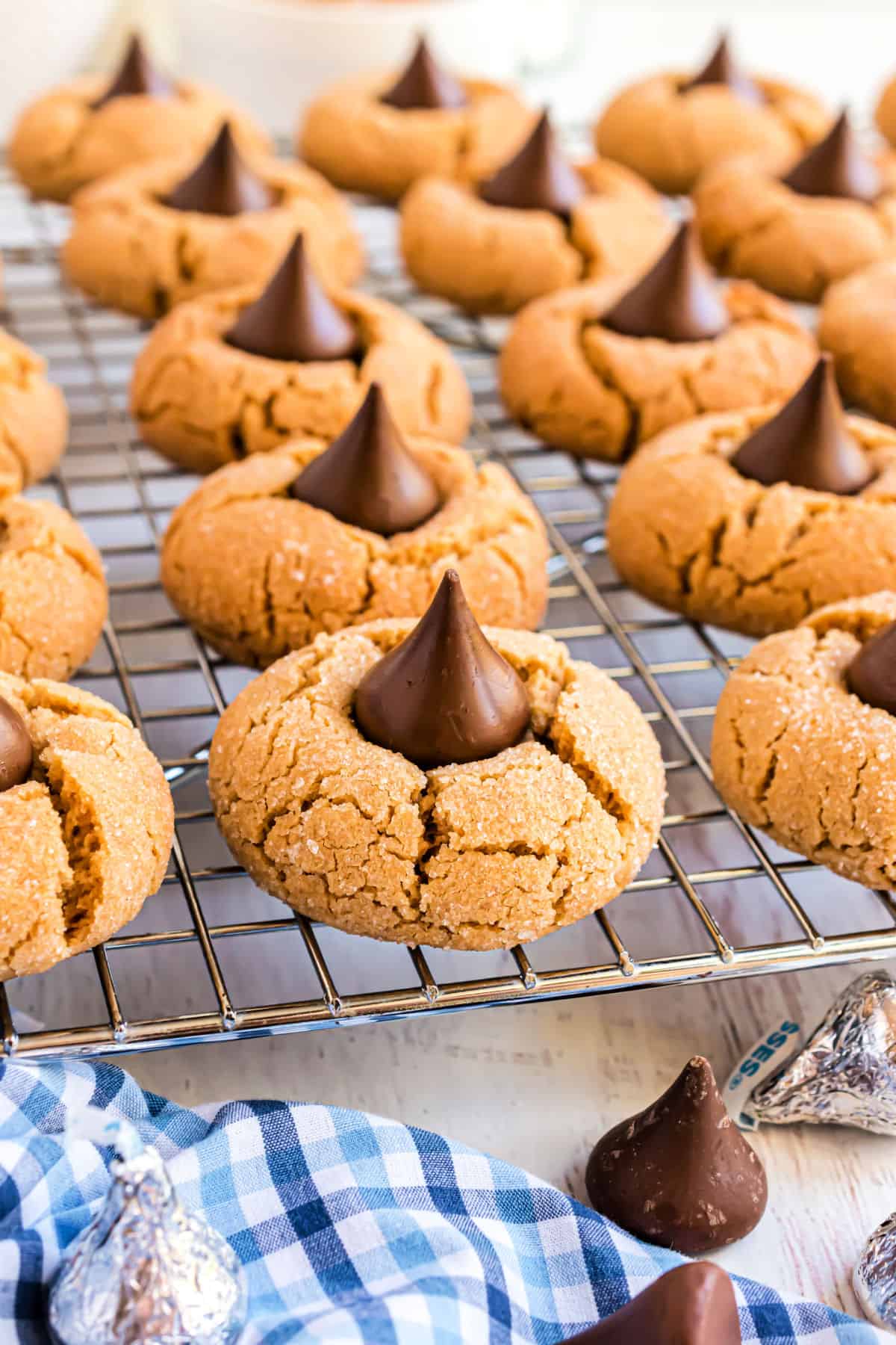 Peanut butter blossom cookies on a wire cooling rack.