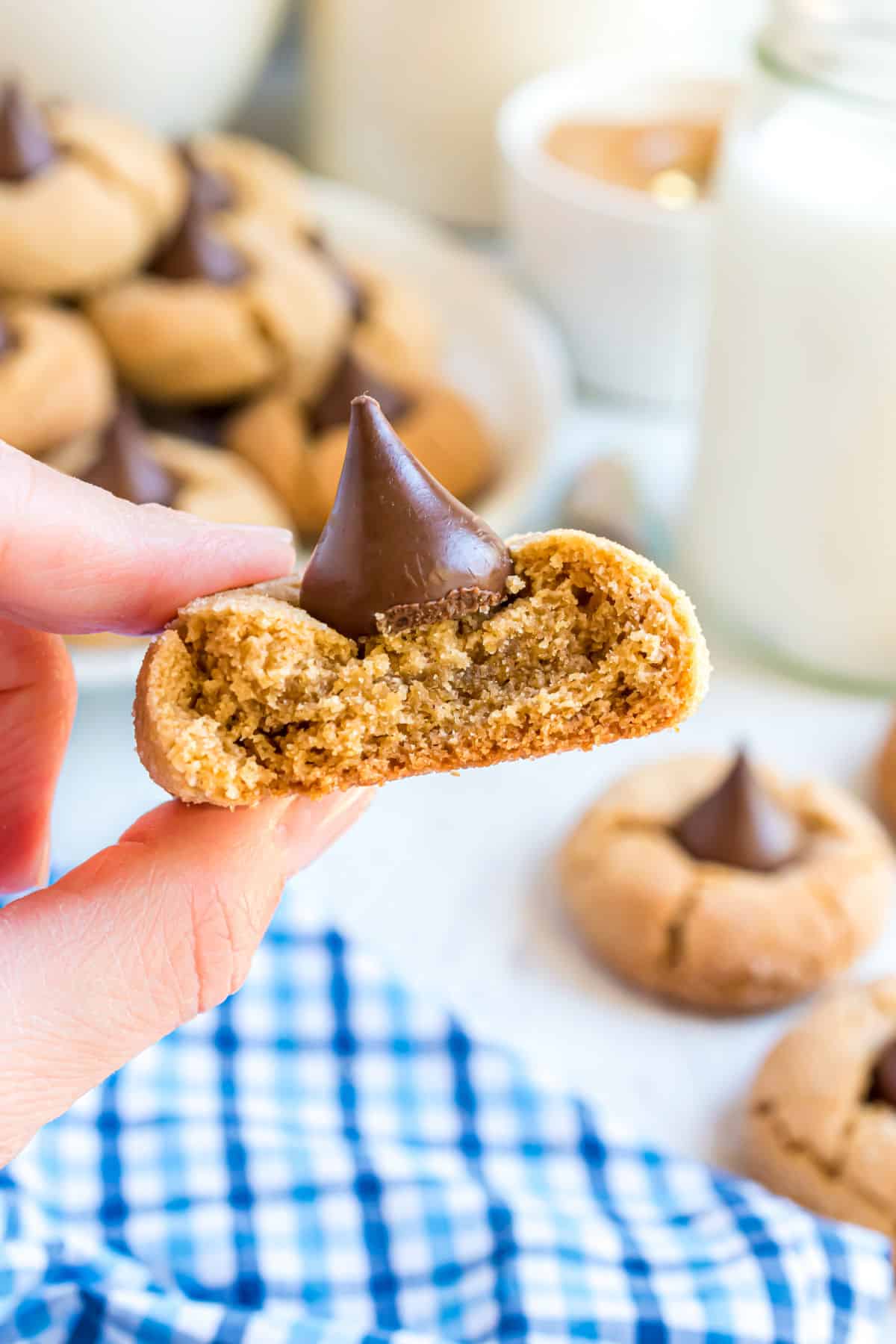 Peanut Butter kiss cookies with a bite taken out.