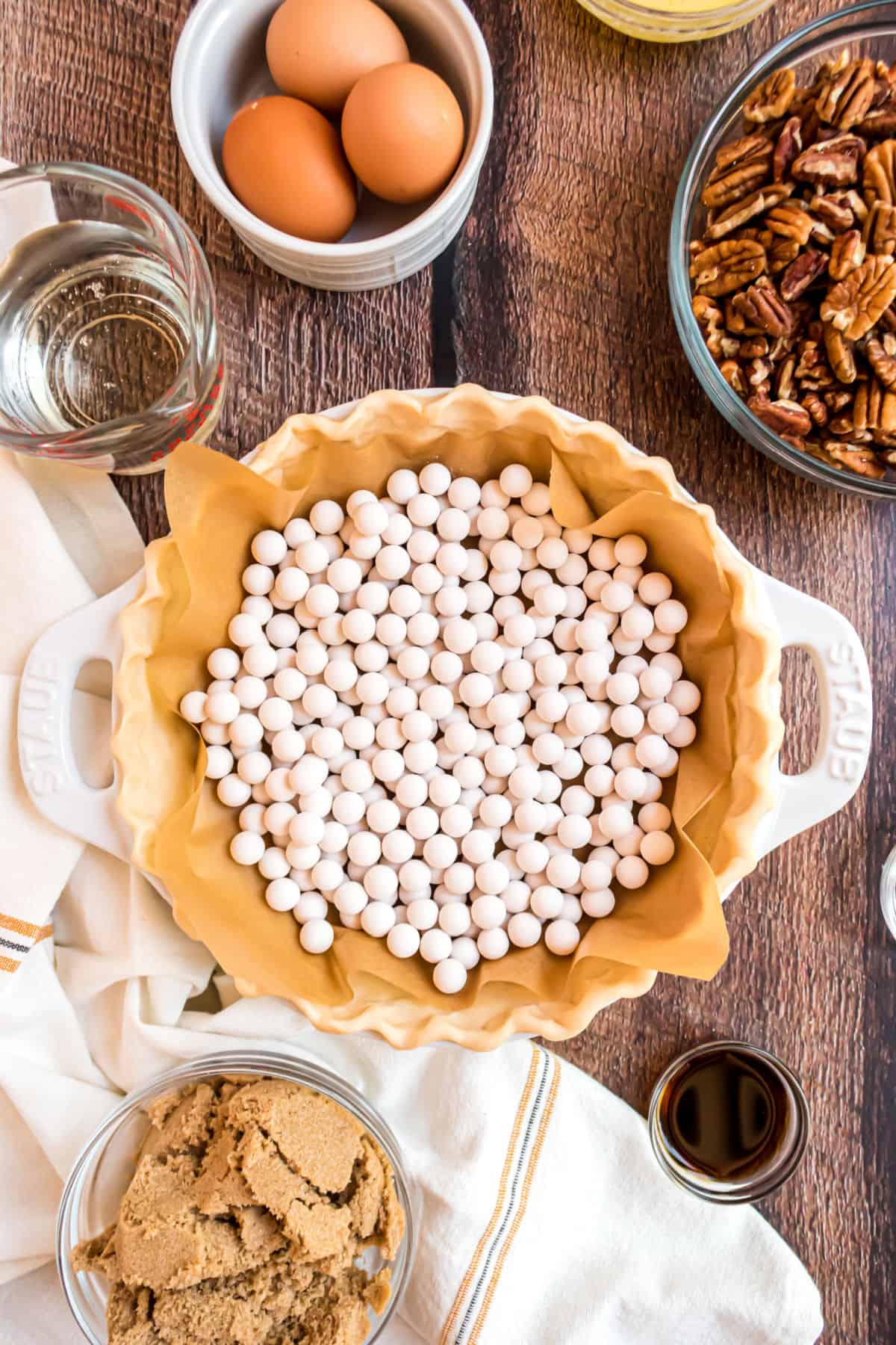 Photo showing how to blind bake a pie crust with pie beads.