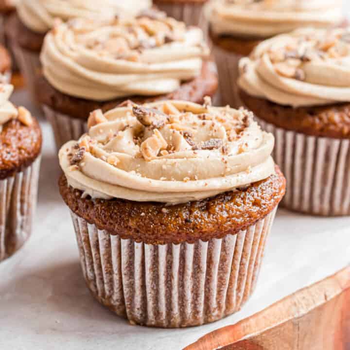 Pumpkin cupcakes topped with maple flavored cream cheese frosting and heath toffee bits.