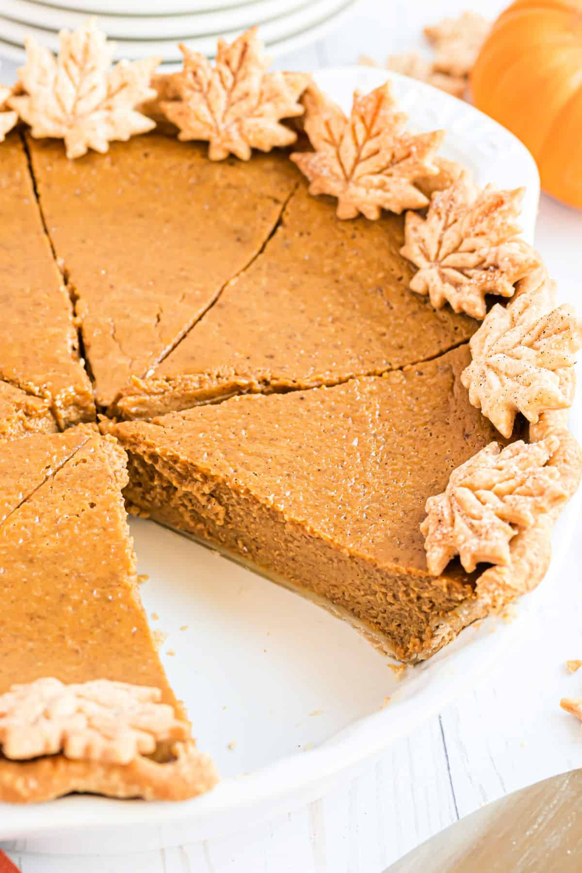 Pumpkin pie with a slice removed.