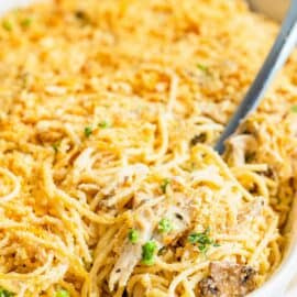 Turkey tetrazzini in a bagkin dish with spoon for serving.
