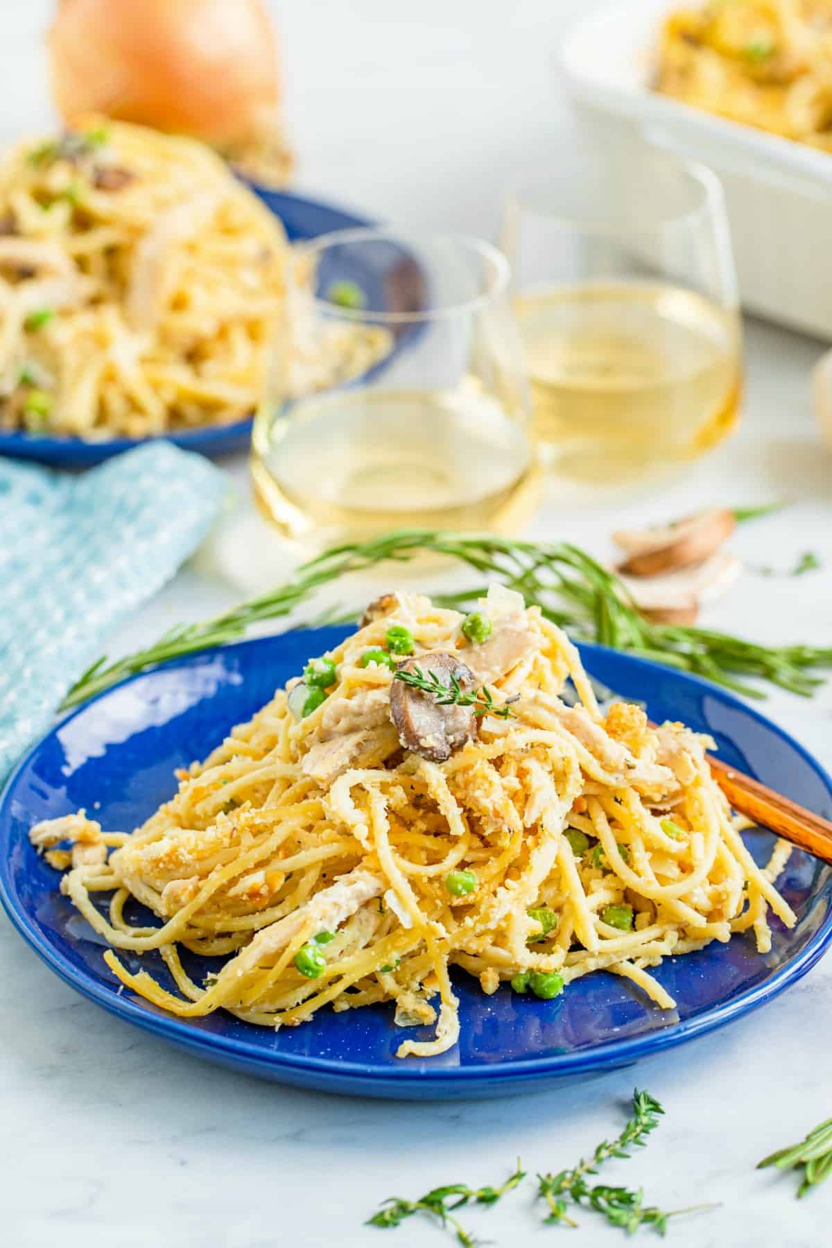 Turkey tetrazzini served on blue dinner plates.