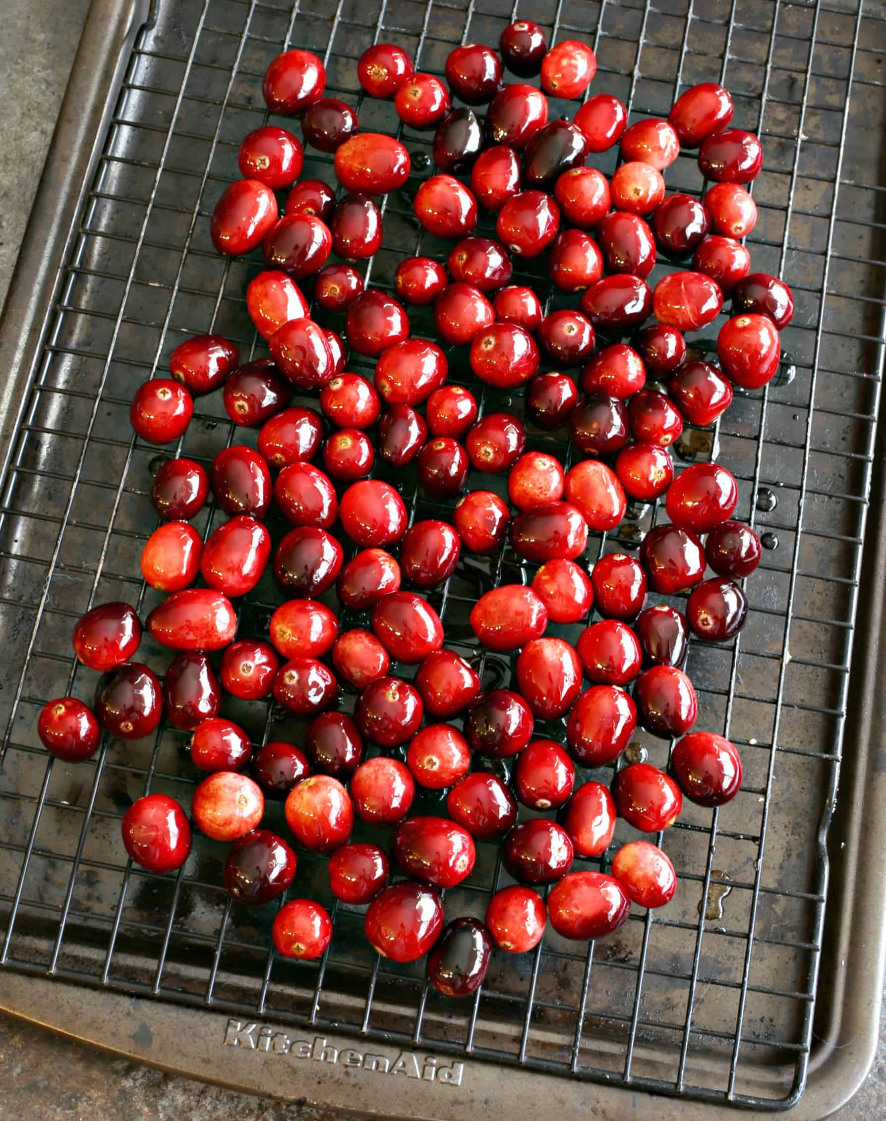 Sugared cranberries on wire rack.