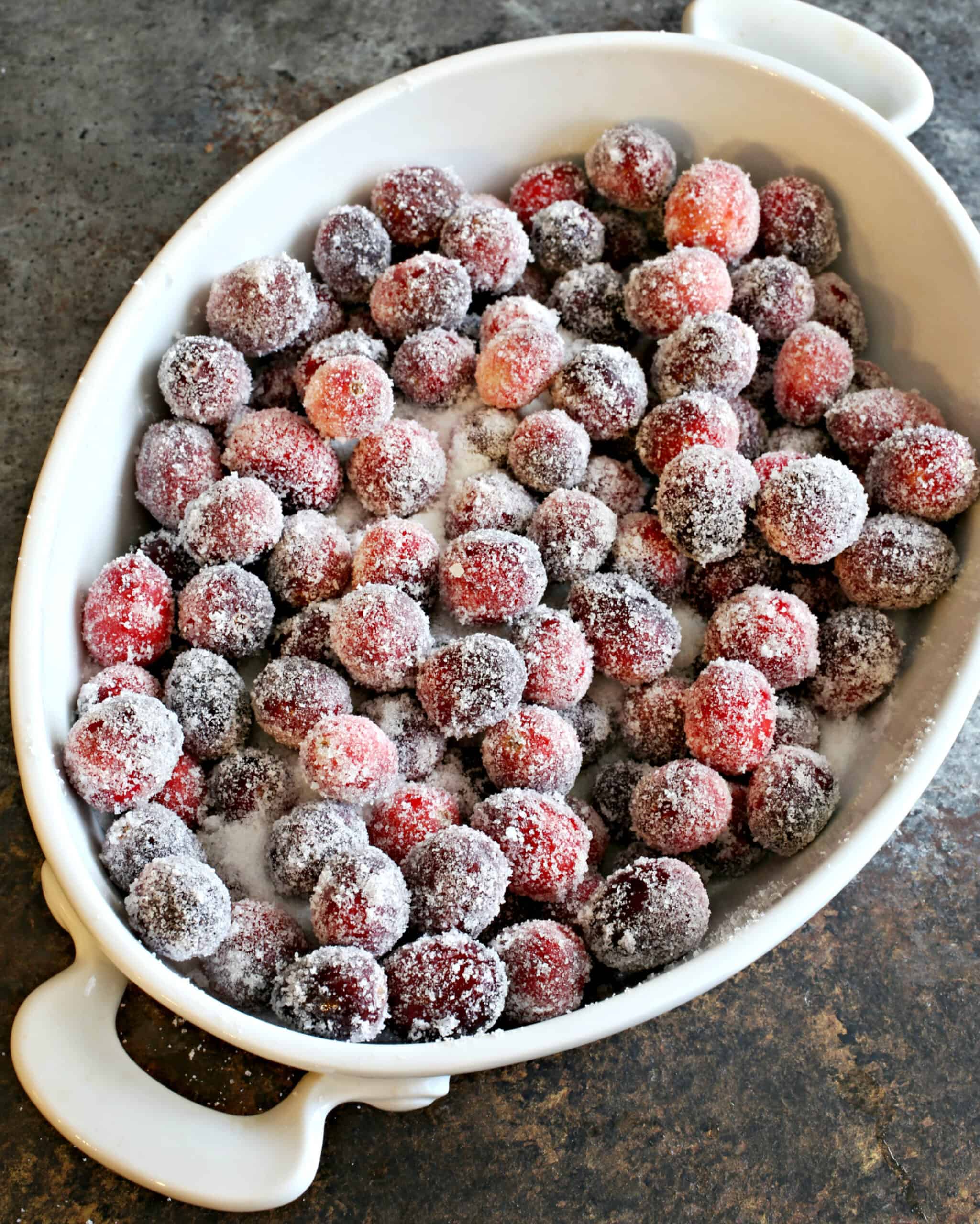 Sugared cranberries in oval baking dish.