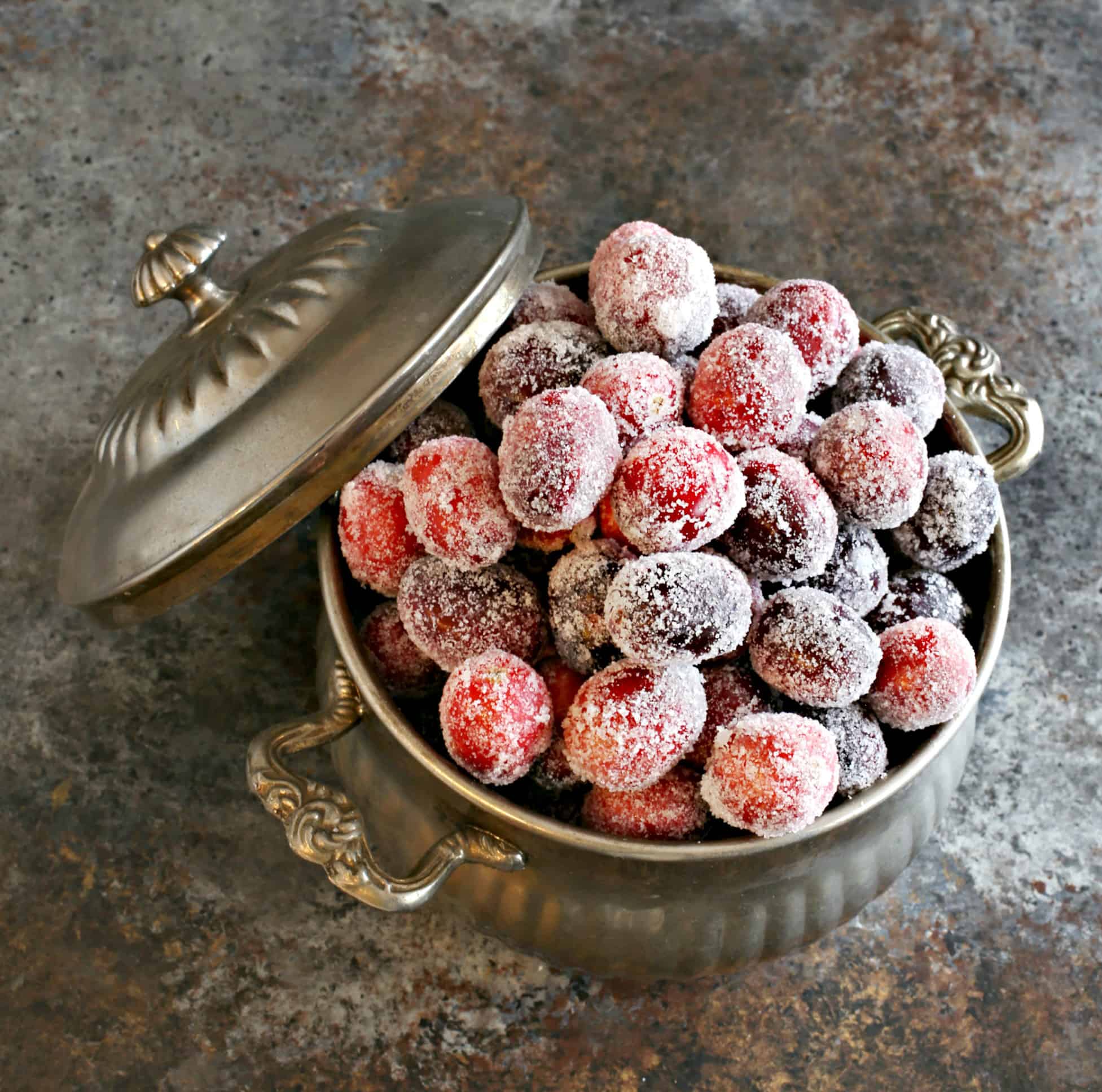 Sugared cranberries in silver bowl.