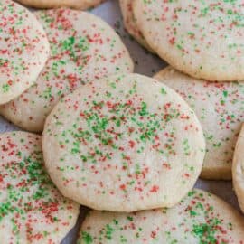 Stack of jingle cookies on parchment paper.