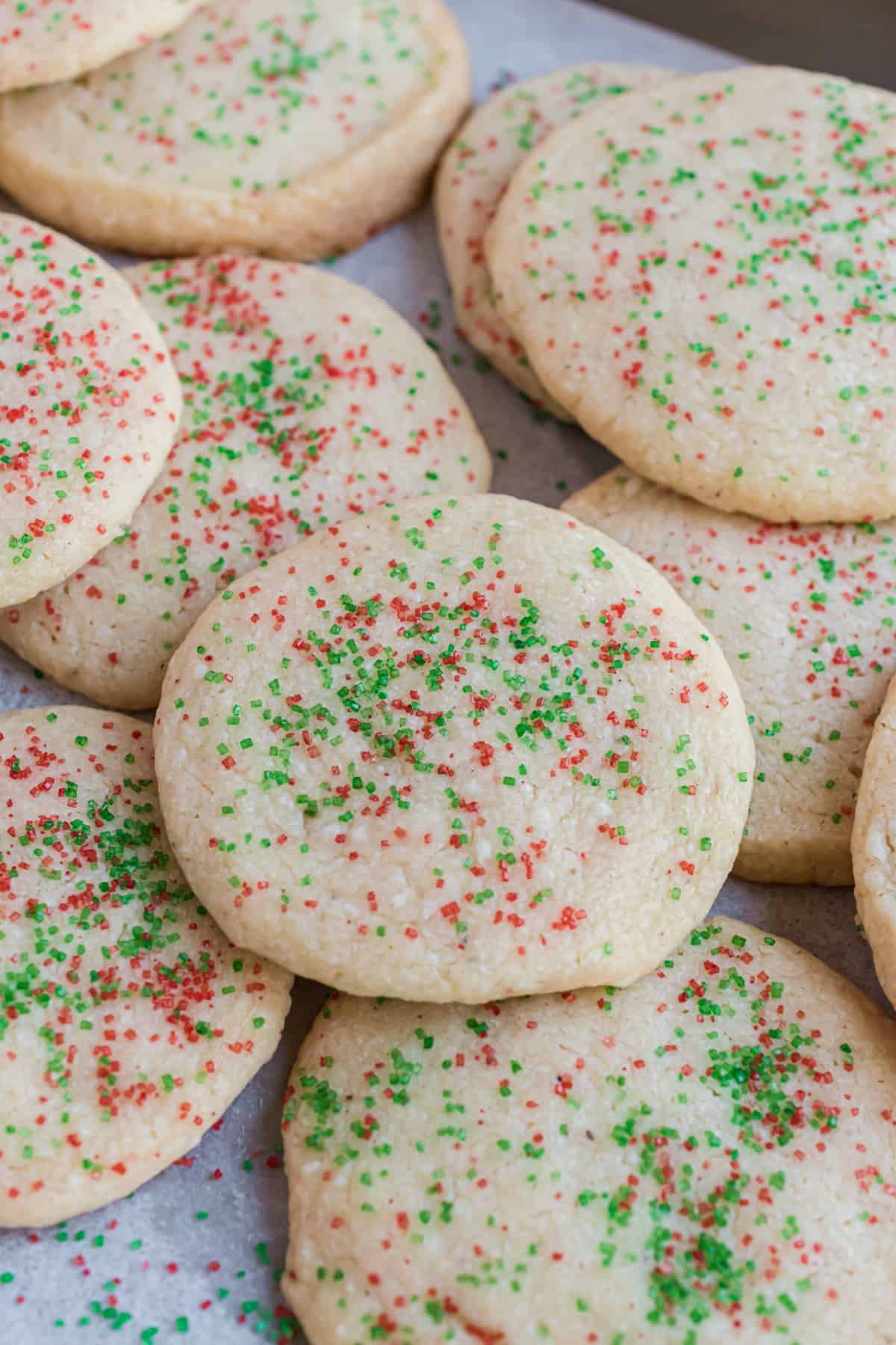 Stack of jingle cookies on parchment paper.