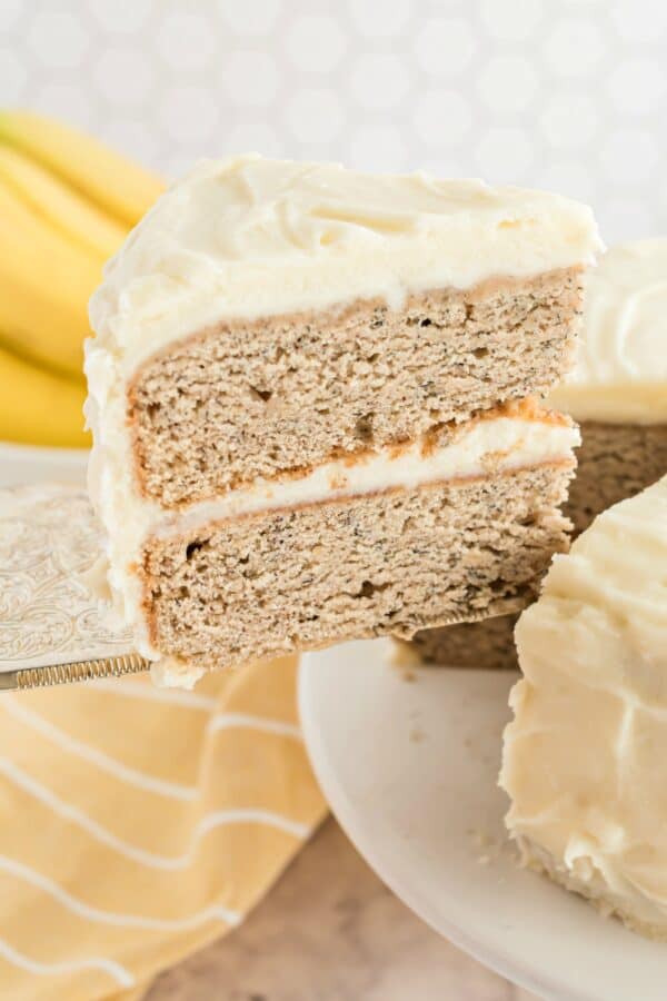 Slice of banana cake with cream cheese frosting.