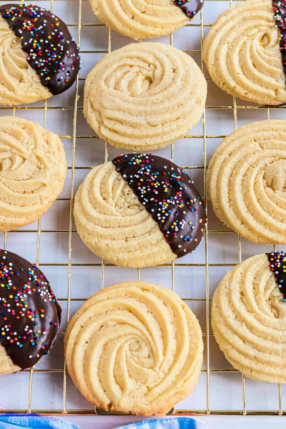 Butter cookies baked and cooling on a rack.