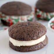 Bake up a batch of these easy Chocolate Whoopie Pies just in time for the holiday season. Soft chocolate cookies sandwiched together with a thick frosting filling and covered in sprinkles make a delicious addition to your cookie tray!