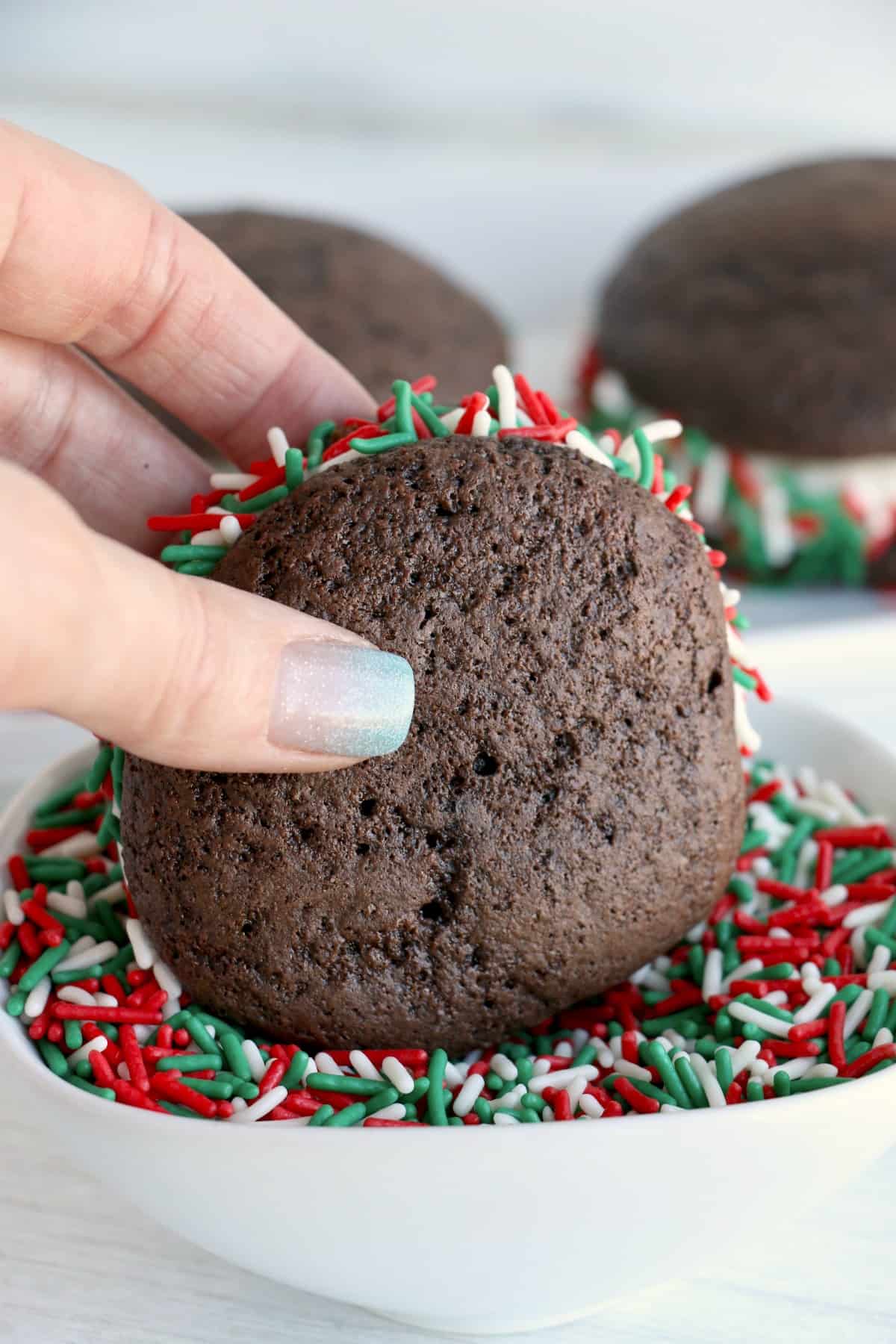 Chocolate whoopie pies dipped in Christmas sprinkles.