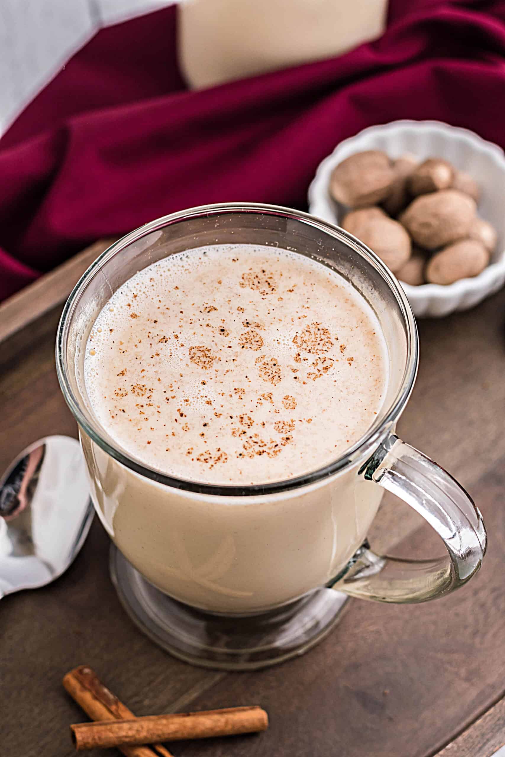 Cold eggnog in a glass mug.