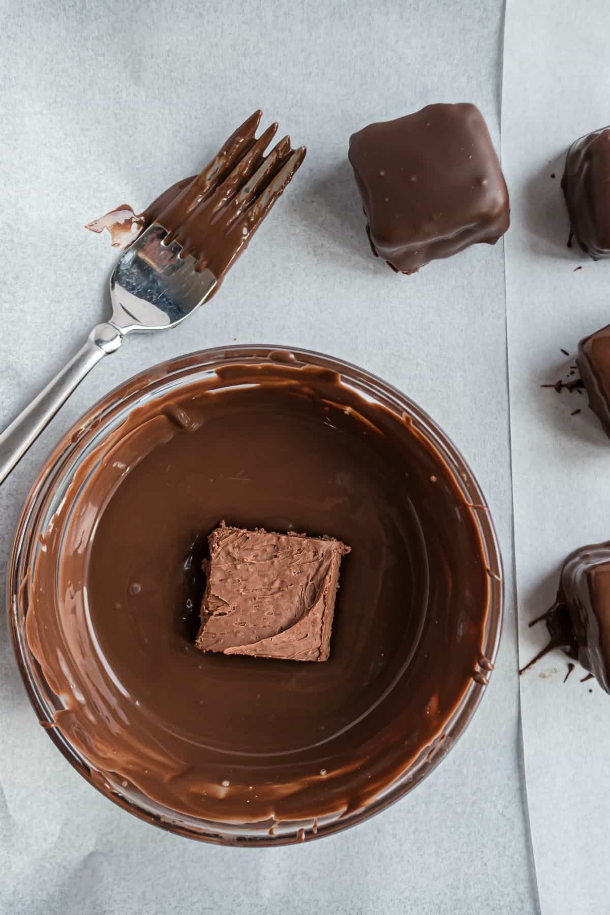 How to dip homemade three muskateers in melted chocolate.