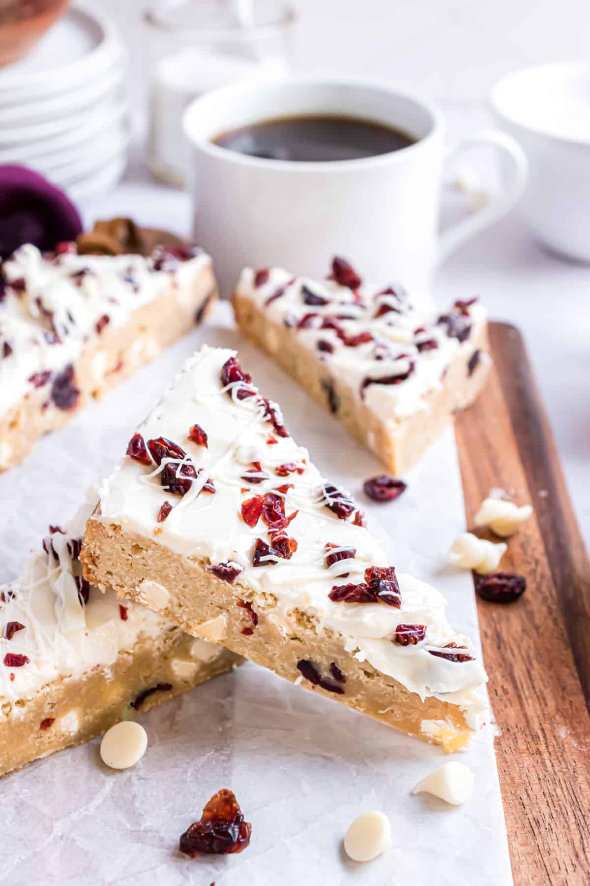 Blondie topped with cream cheese frosting and craisins, cut into triangles.