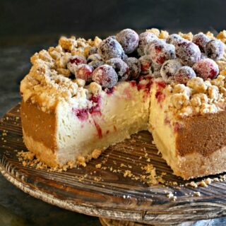 Cranberry Cheesecake with a delicious shortbread cookie crust and crumble and fresh cranberry swirl is a delightful holiday dessert! Topped with more sugared cranberries, this cheesecake looks as good as it tastes.