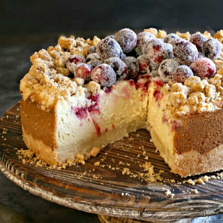 Cranberry Cheesecake with a delicious shortbread cookie crust and crumble and fresh cranberry swirl is a delightful holiday dessert! Topped with more sugared cranberries, this cheesecake looks as good as it tastes.